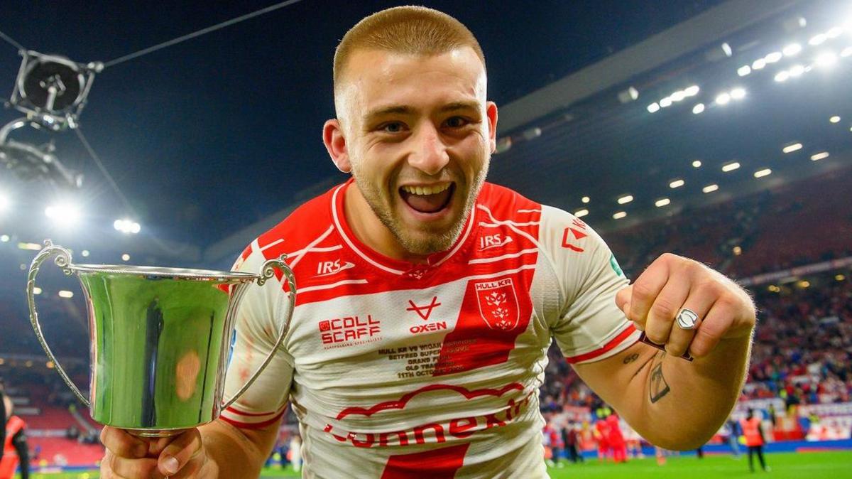Hull KR's Mikey Lewis celebrates with the Rob Burrow Award trophy and his Grand Final winner's ring.