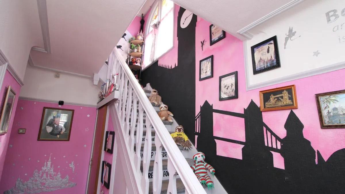 A Disney-themed staircase features a silhouette of the London skyline