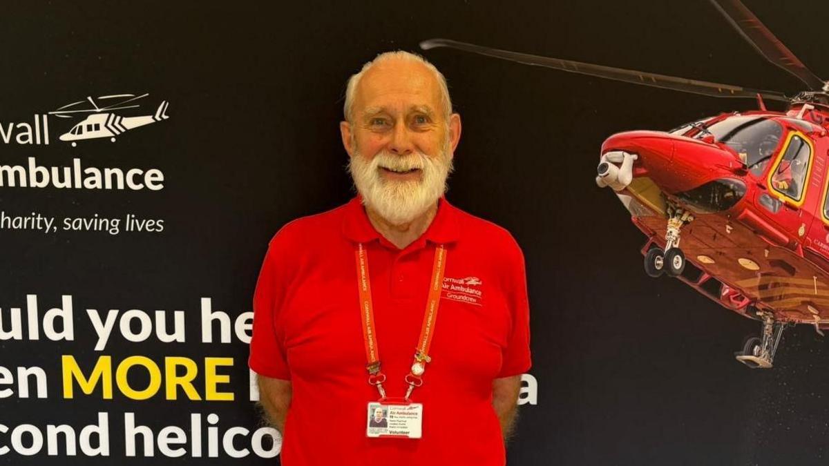 Paul Ford, from Launceston, stood in front of a Cornwall Air Ambulance display, wearing a red polo shirt, and sporting a neat short beard and moustache