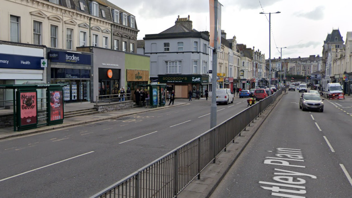 A Google street view image of Mutley Plain. Shops can be seen either side of the road.