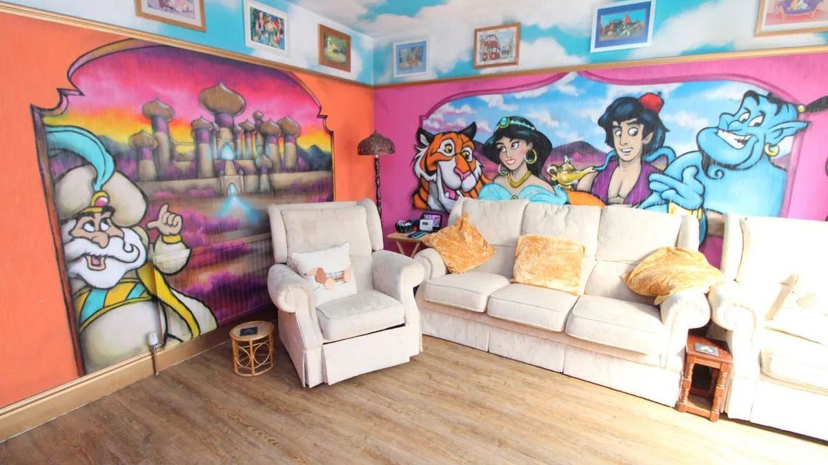 A living room featuring Aladdin characters painted on the walls