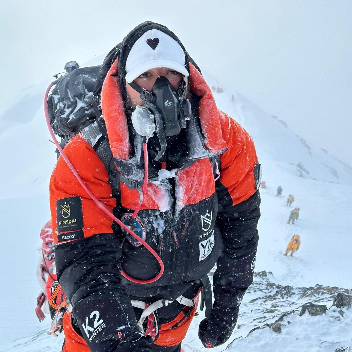 A man in mountain gear crusted with ice