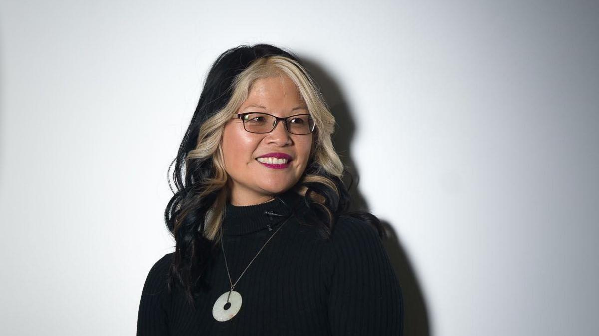 Dr Audrey Tang, smiling, wearing a black top