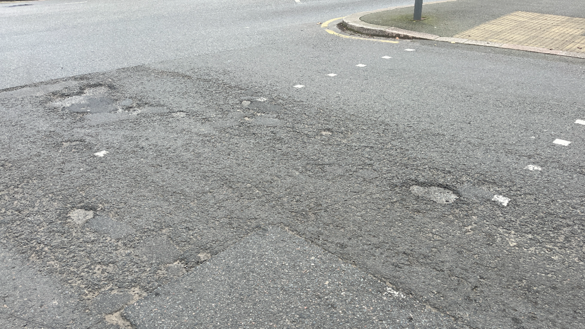 A downward view of a damaged road in Jersey.