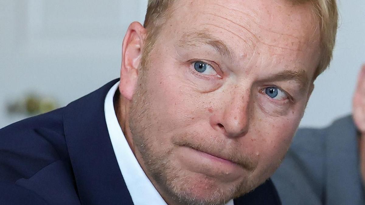 Chris Hoy, wearing a blue jacket and white shirt
