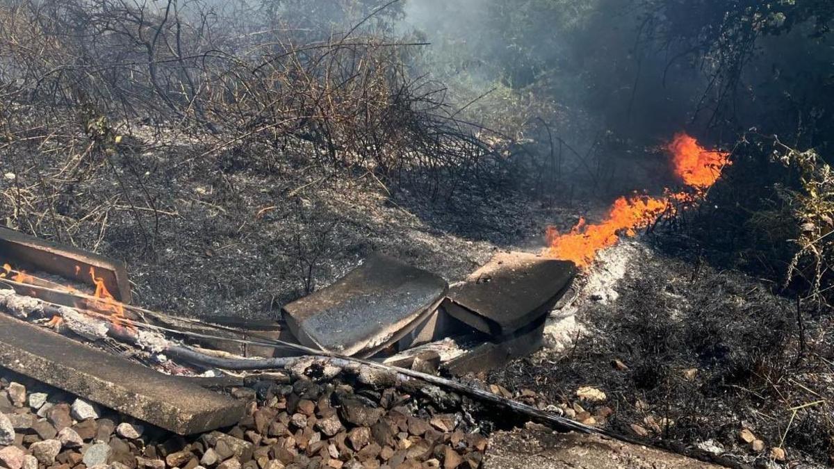 Electric cable on fire beside rail line