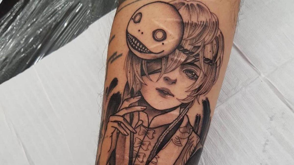 A close up picture of a tattoo in black ink depicting an anime character. There are self-inflicted scars visible underneath the design 