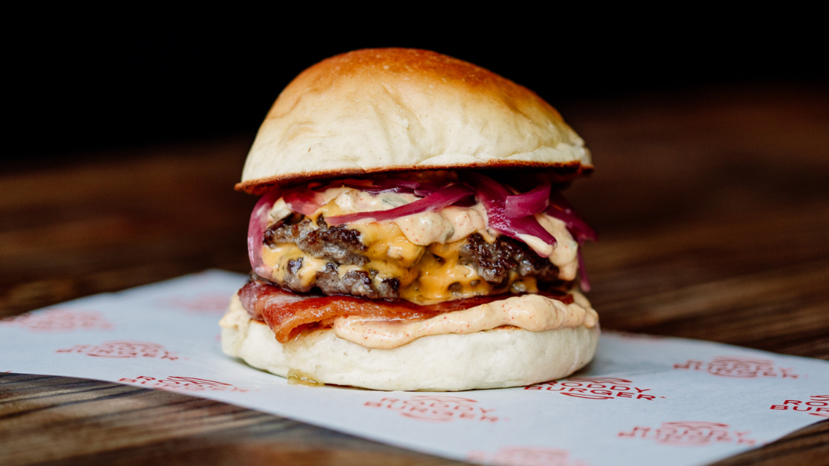 A burger on a white piece of paper with "Roddy Burger" written on it.