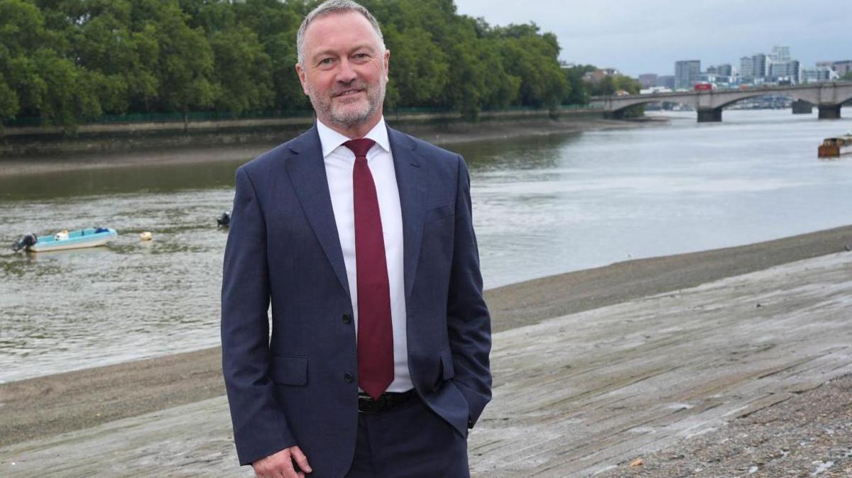 Steve Reed stands in front of the River Thames