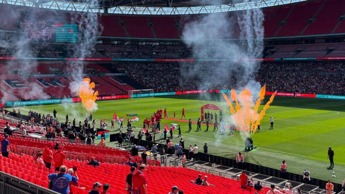 A football stadium with flares going off.