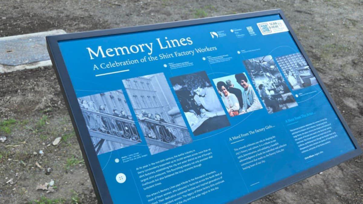 A blue plaque with a number of photos on it tells the story of shirtmaking in derry