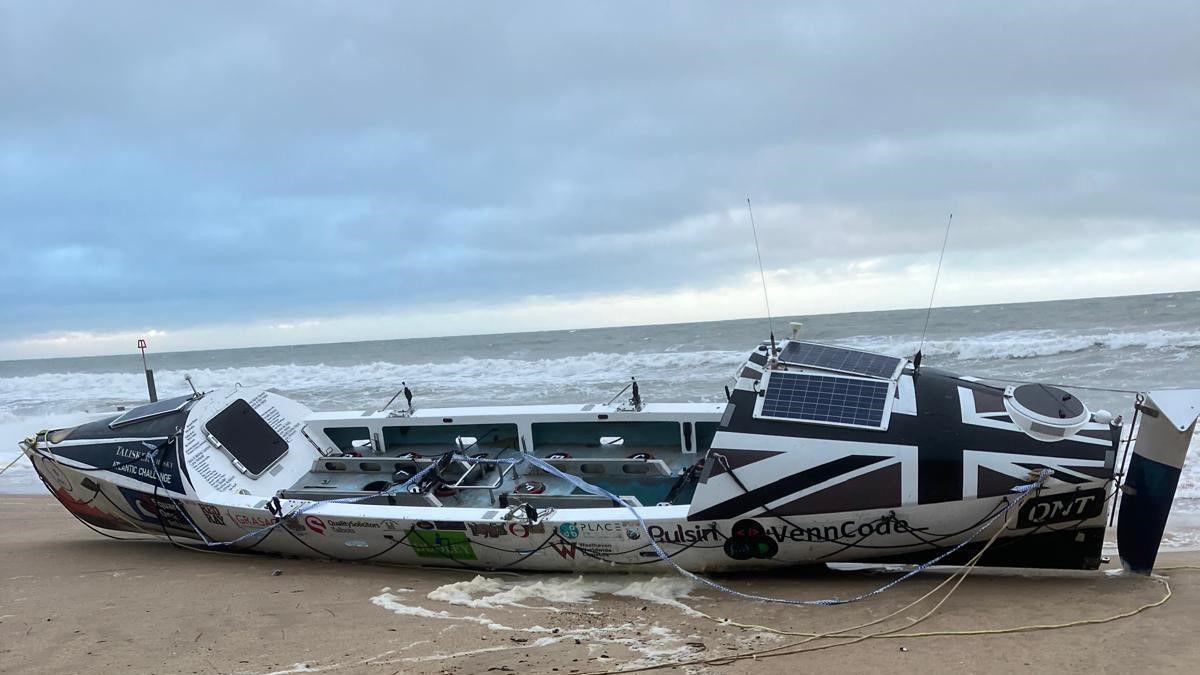 A large rowing boat on the beach