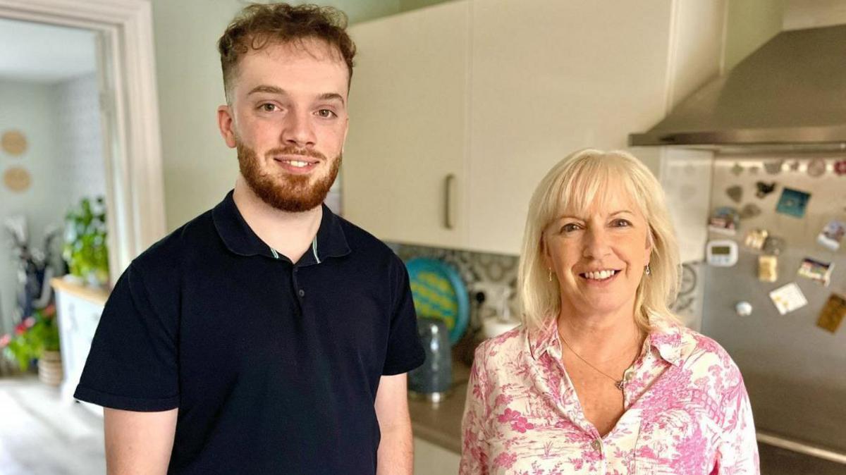 Joe and his mother Amanda Burgess in a kitchen