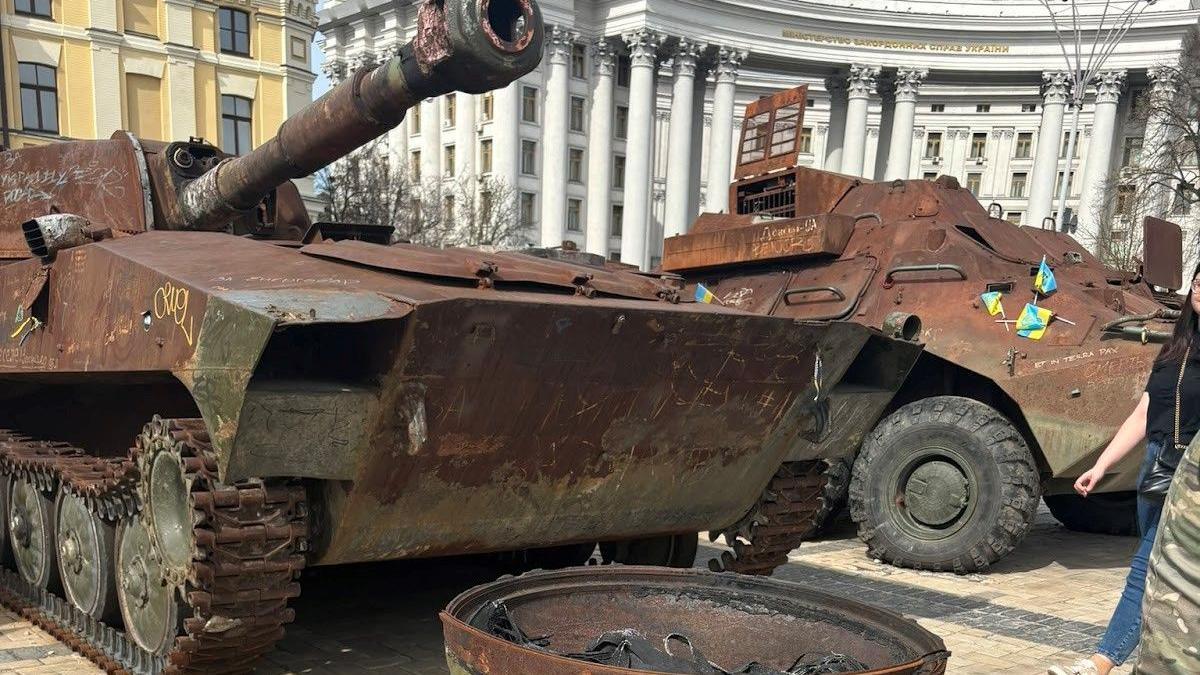 Rusting and fire-damaged tanks stand in a square in Kyiv