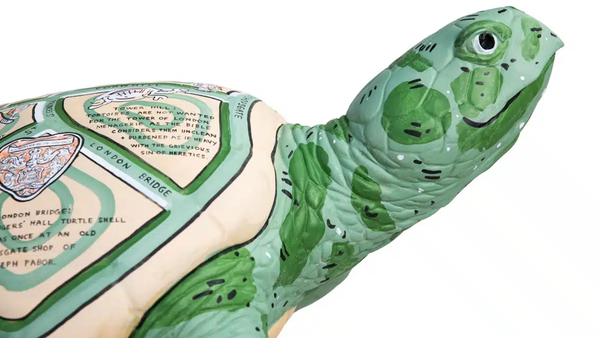 Close up of turtle sculpture - showing pictorial maps on its back 