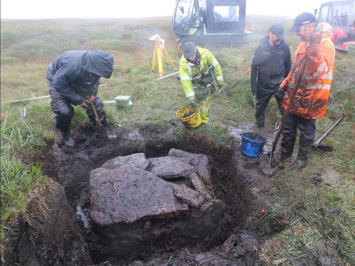 Archaeologists exploring cist at Cut Hill during excavations. 