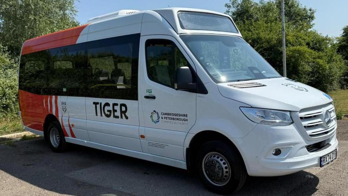 A red and white bus with "Tiger" written on the side