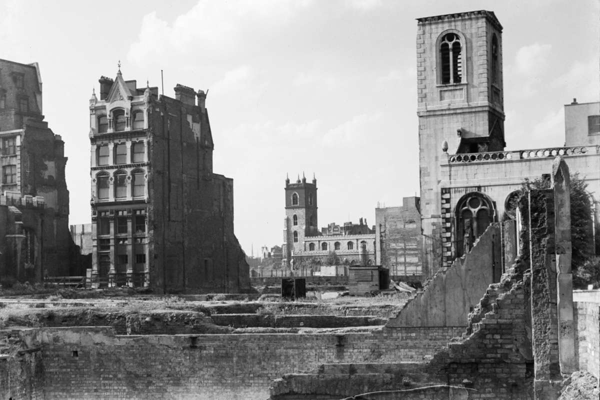 Black and white image of ruins in the City of London in 1946 with few buildings standing and the wreckage of St Mary Aldermanbury on the right and St Giles' Cripplegate in the distance