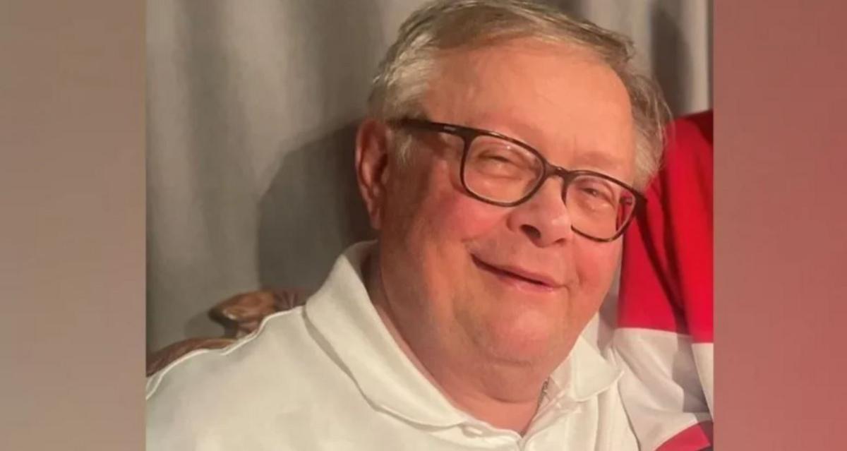 A family-issued photograph of Stuart Everett. He has grey hair and is wearing dark glasses in the photograph. Smiling, he is wearing a white polo shirt.
