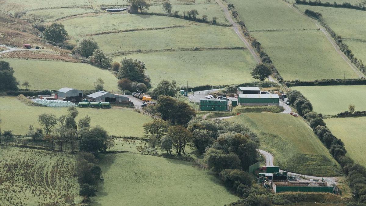 A compound of corrugated iron buildings amid the rolling hills and green fields in the Sperrins area of County Tyrone