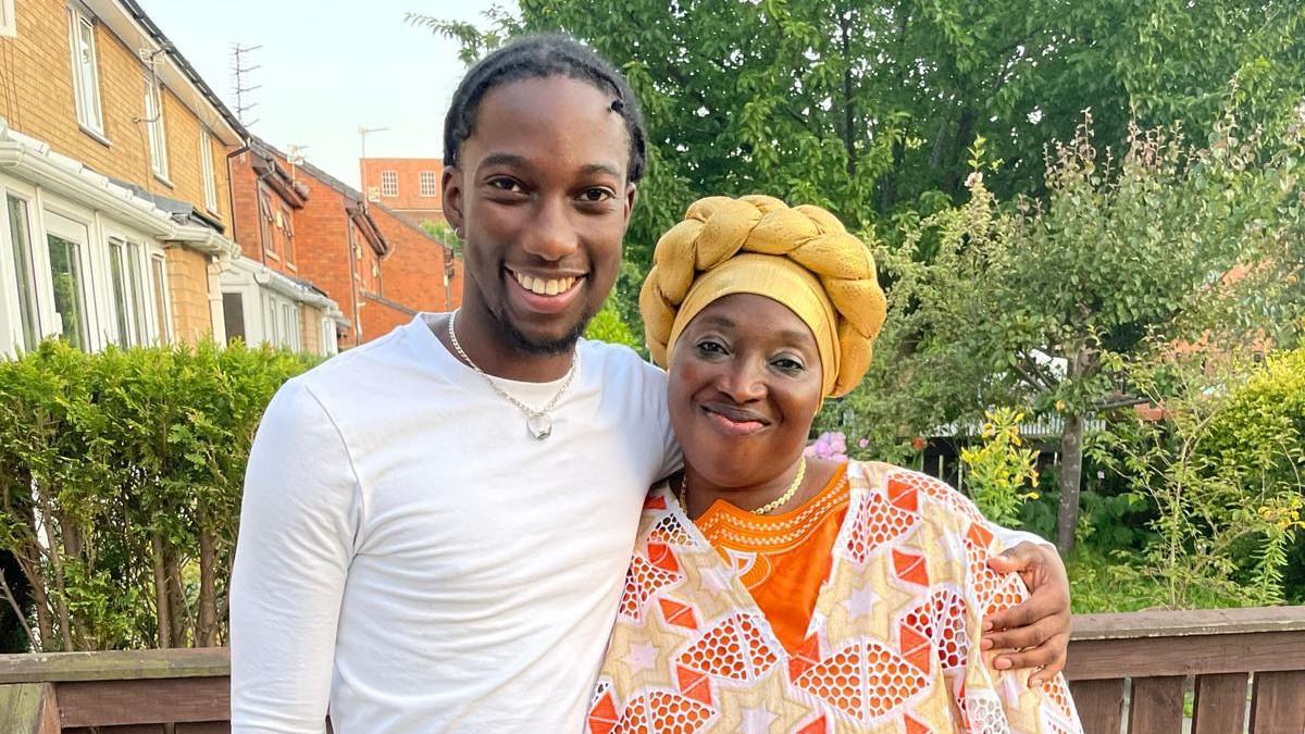 Baka Bah and his aunt Suwaidu Sanyang smile for the camera on a sunny day