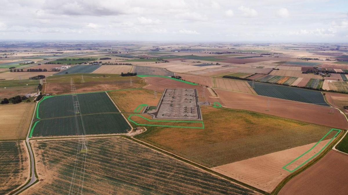 An aerial picture of fields with a green line outling the proposed site for one of the two proposed substations. 