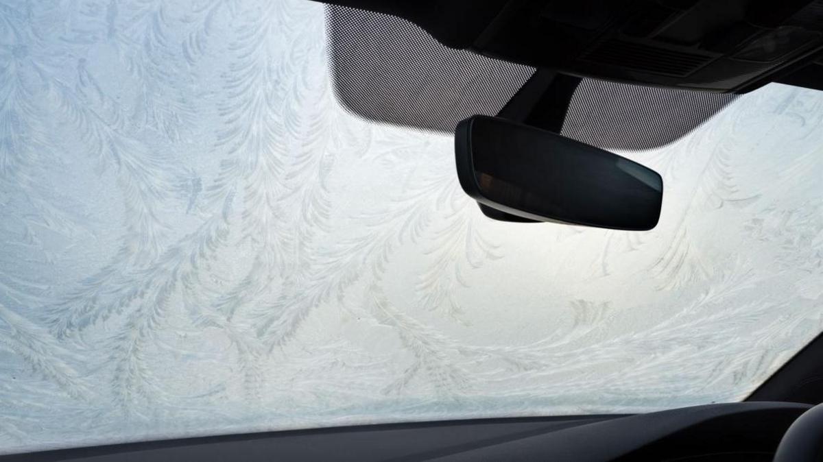 The inside of a car windscreen covered in frost. 