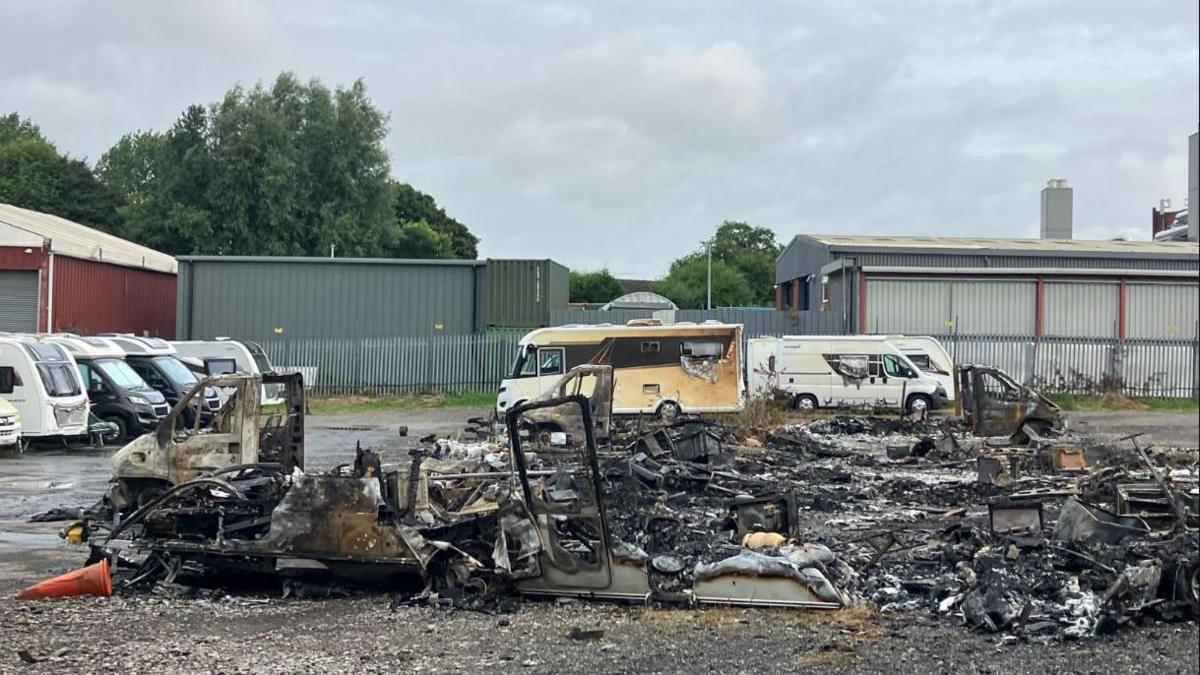 Vehicles completely destroyed by a now extinguished fire at a caravan and motorhome storage facility.