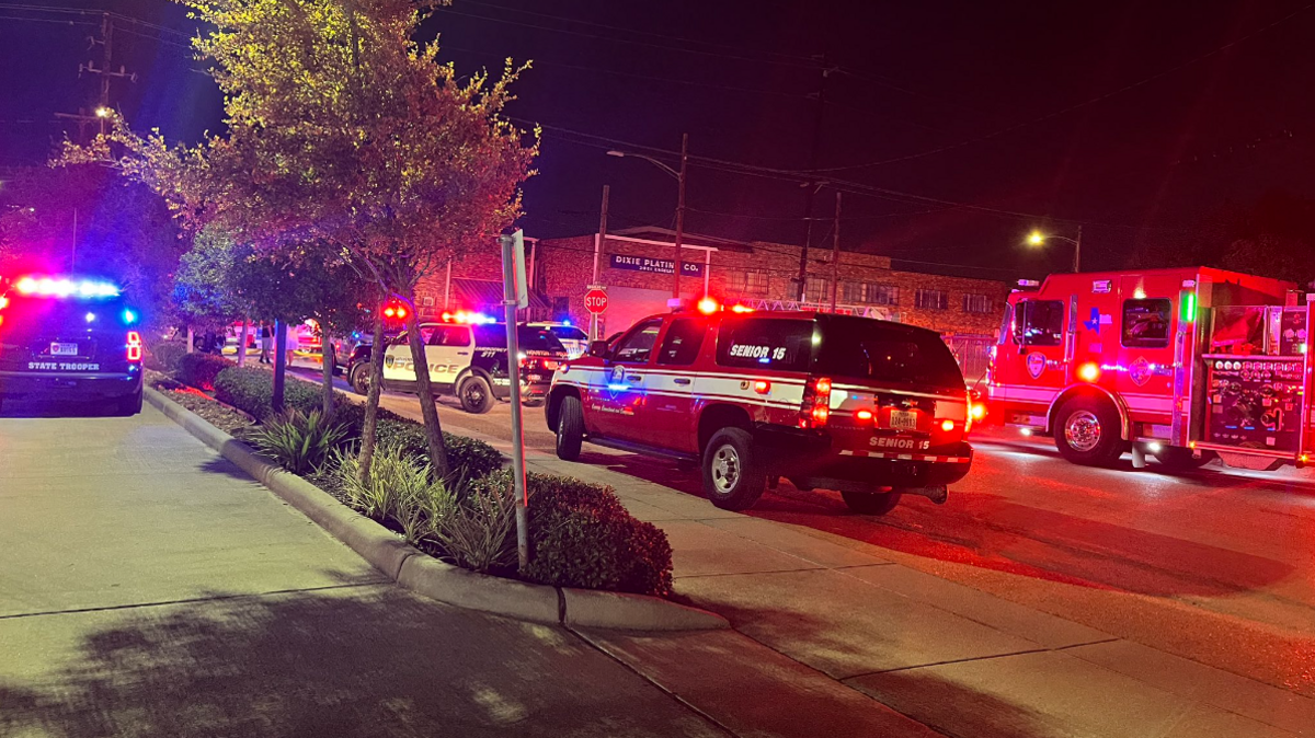 Emergency vehicles driving towards the scene of the crash on a Houston road.