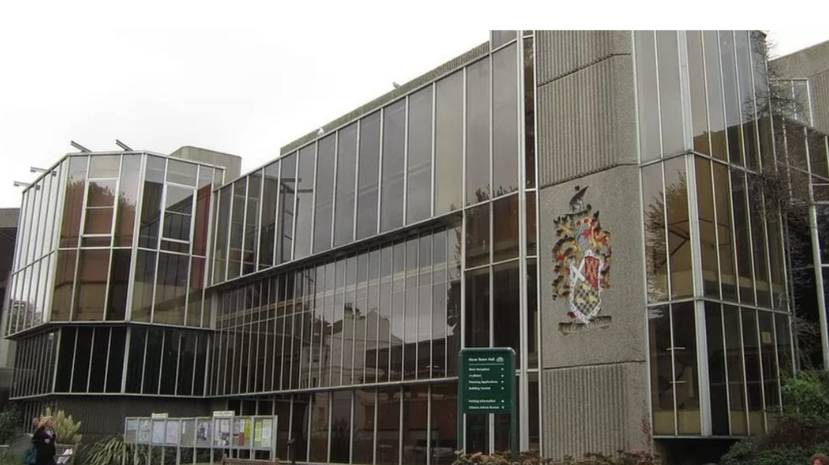 An external view of Hove Town Hall, a brutalist structure of straight angles, concrete and glass.