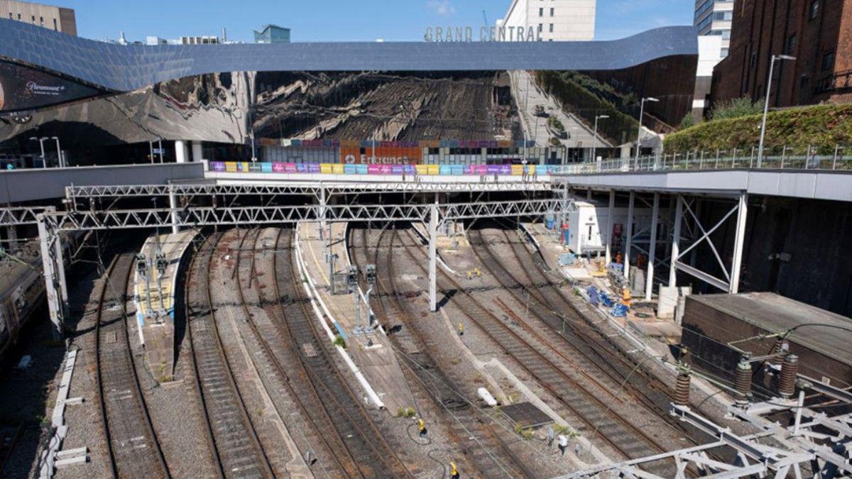 A number of tracks in the area of New Street station. The words Grand Central, for the shopping centre in Birmingham, are above the station building at the top of the image.