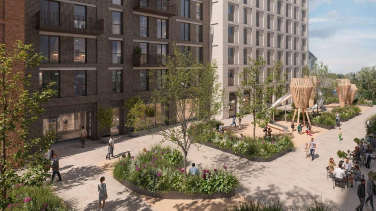 A CGI image of tall flat buildings surrounding a communal area.