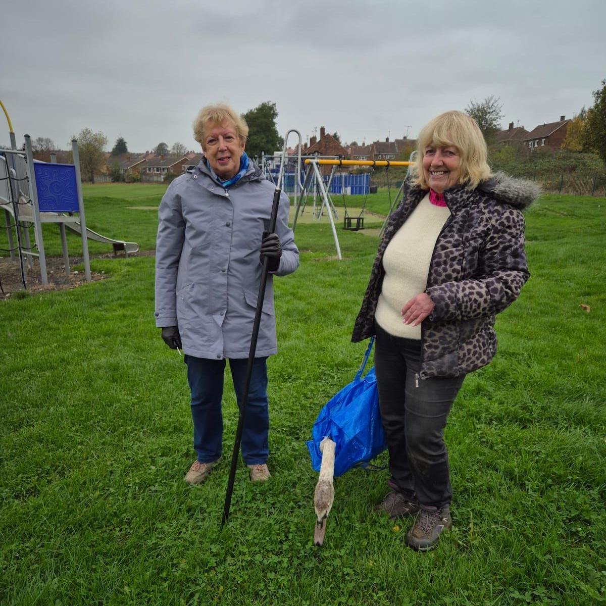 The swan in a bag with two volunteers from Yorkshire Swan & Wildlife Rescue Hospital.