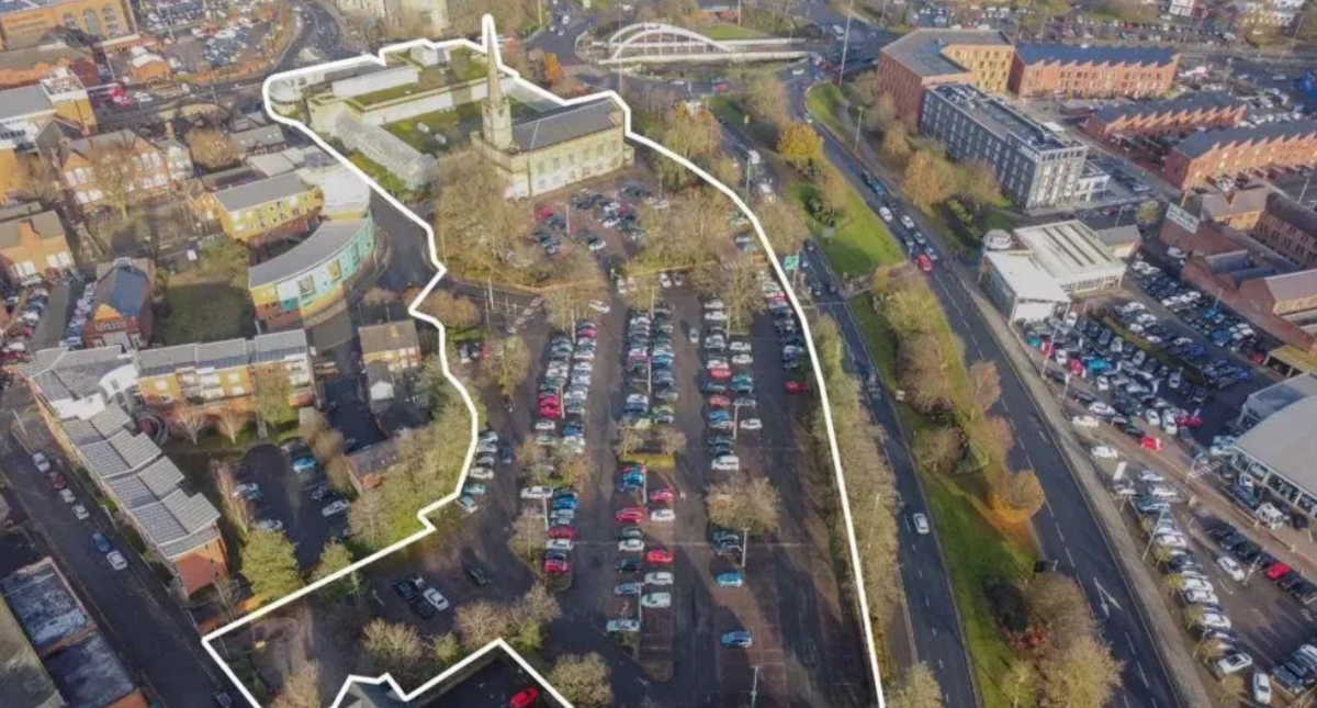 Aerial view of the development site, which is largely a car park