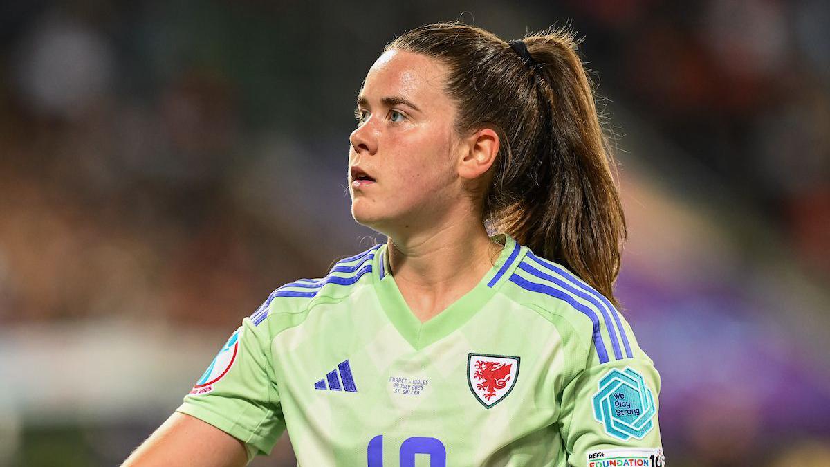 Esther Morgan wears a green Wales team shirt