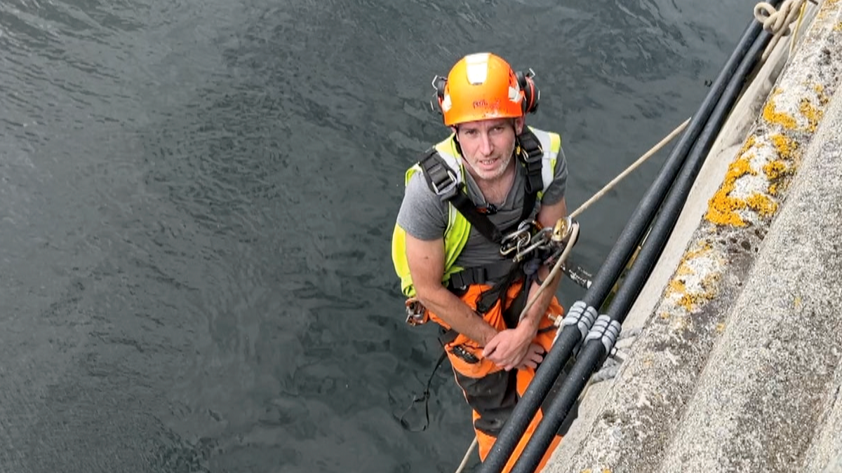 Man abseiling doing concrete repairs