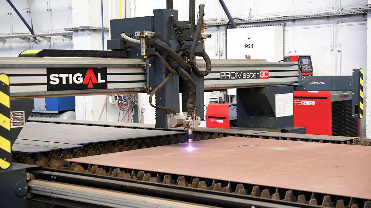 A gas steel cuter is seen cutting through a steel panel