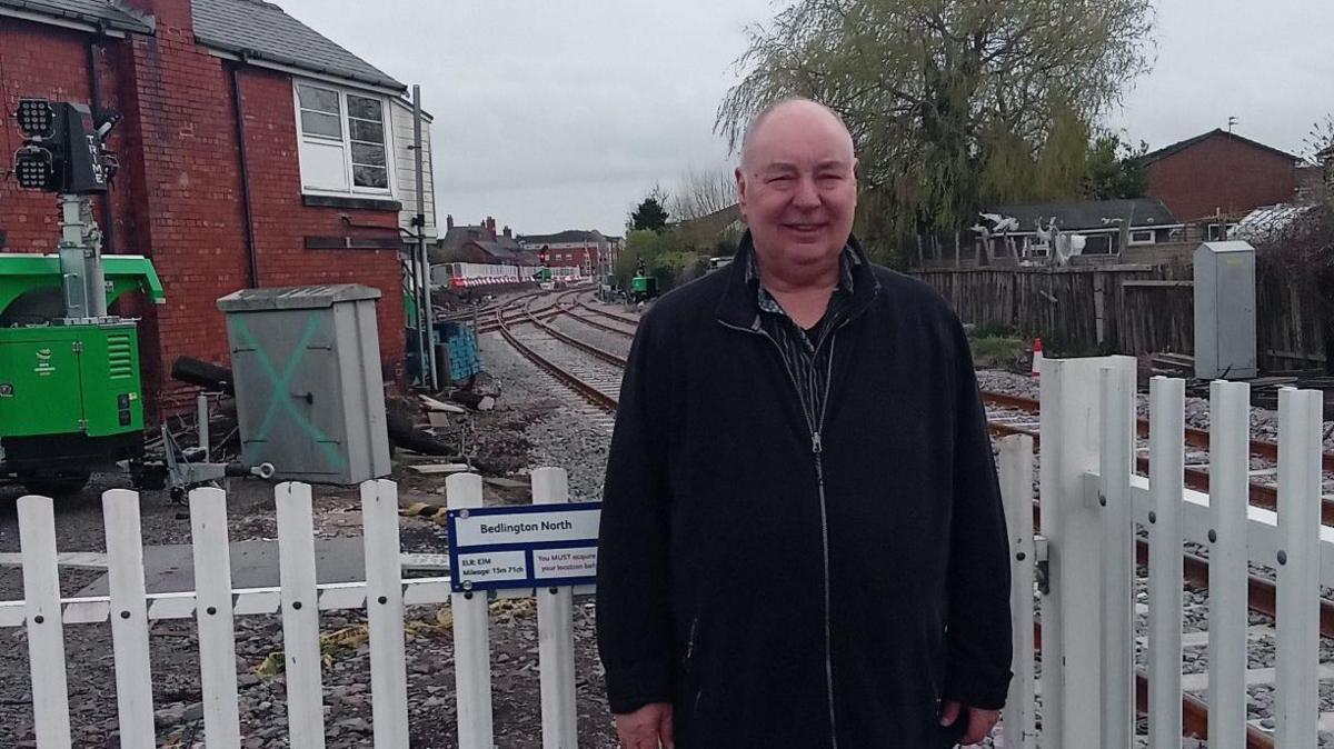 Dennis Fancett at Bedlington station with the line behind 