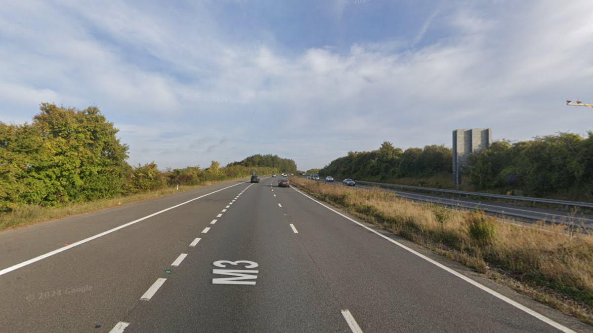 A screenshot from Google street view showing a stretch of the M3. It's a three-lane motorway with trees on each side.