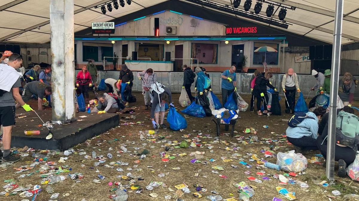 A group of volunteers picking up litter from the ground