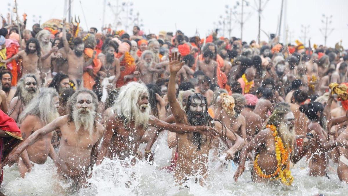 Holy men seeing rushing into the river for a dip