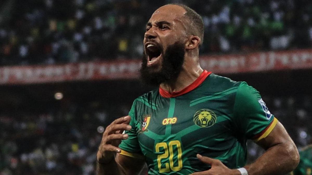 Bryan Mbeumo, wearing a green Cameroon shirt with a yellow number 20 on the chest, is seen shouting as he celebrates a goal