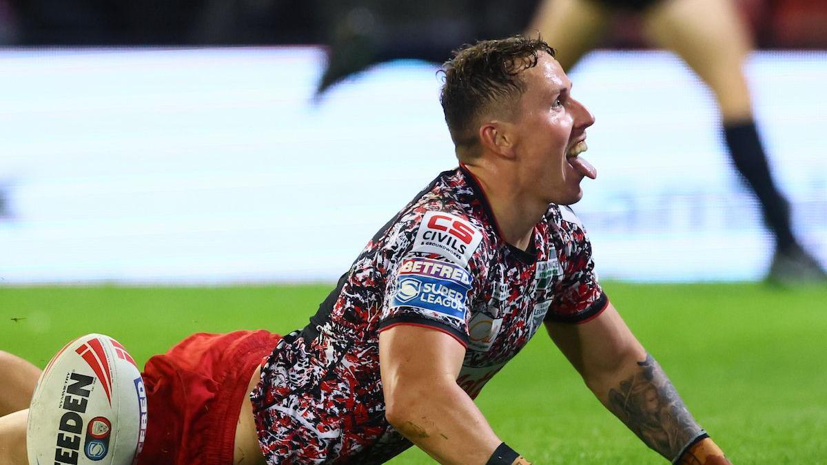 Adam Cook, of Leigh Leopards, pulling his tongue out in celebration after scoring a try