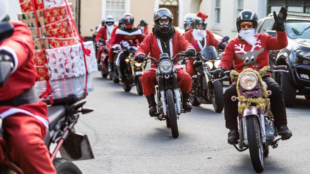 A line of motorcyclists dressed as Santa taking part in a rideout.