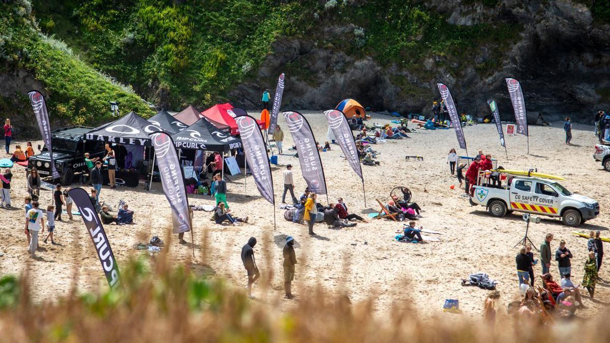 People on beach at surfing competition