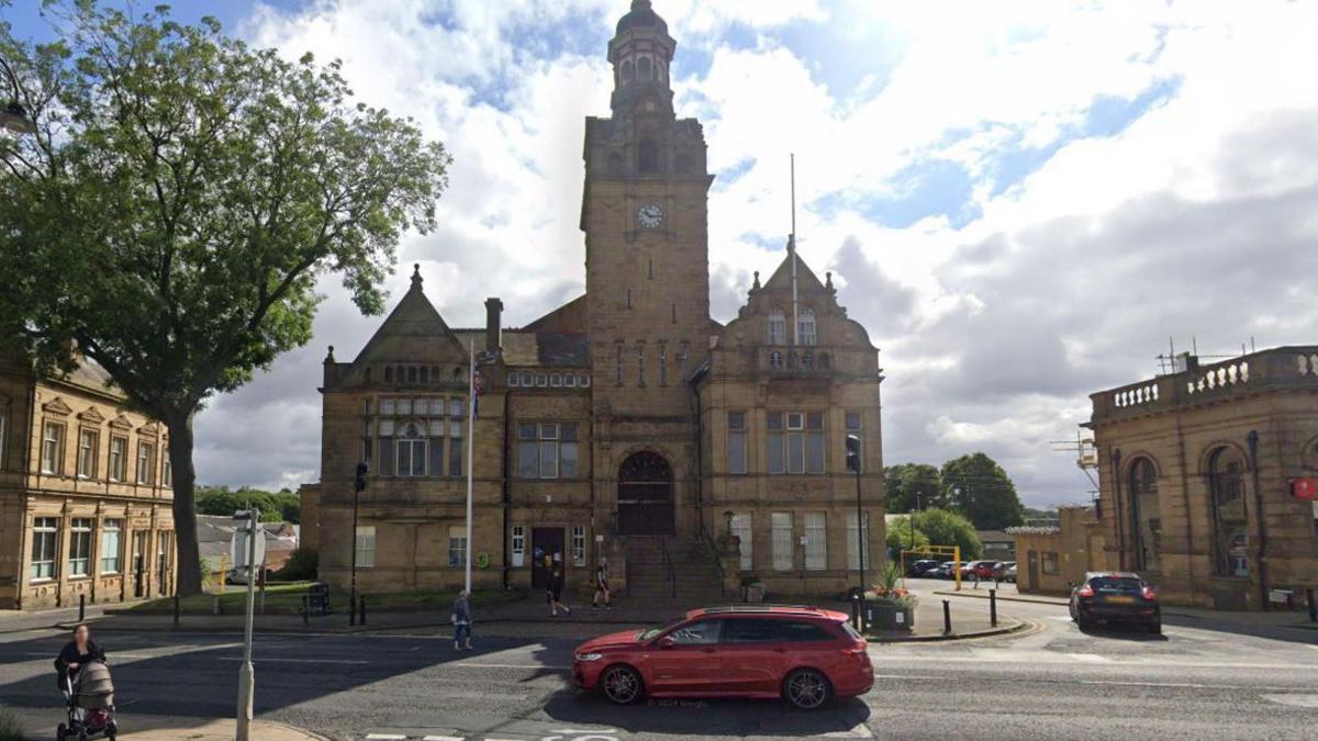 Cleckheaton Town Hall with people walking in front of it