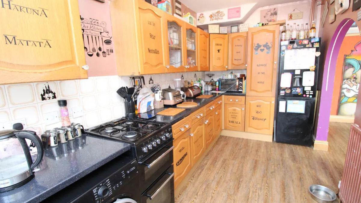 A kitchen with Disney song titles emblazoned on its cupboards