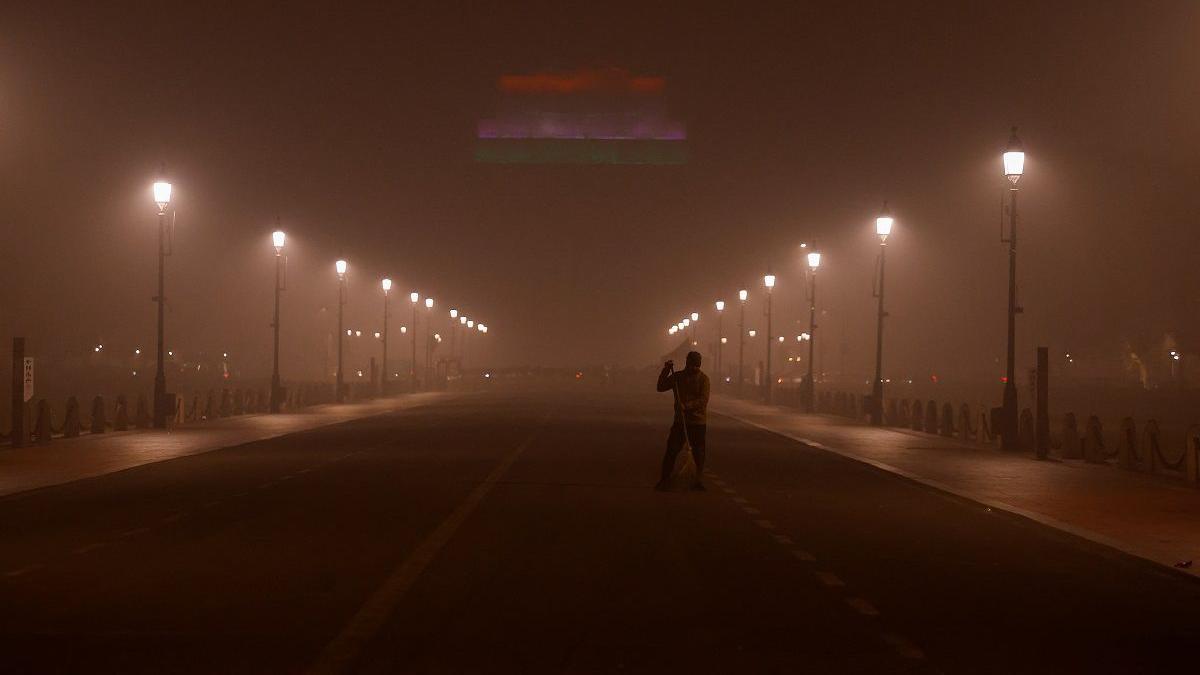 A man sweeps a road near India Gate as the sky is enveloped with smog after Delhi's air quality turned "severe" due to alarming air pollution, in New Delhi, India, November 18, 2024. REUTERS/Anushree Fadnavis
