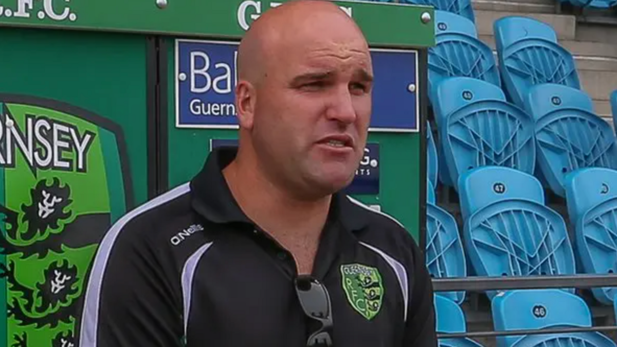 An older picture of Jordan Reynolds. He has no hair and no beard in this image.