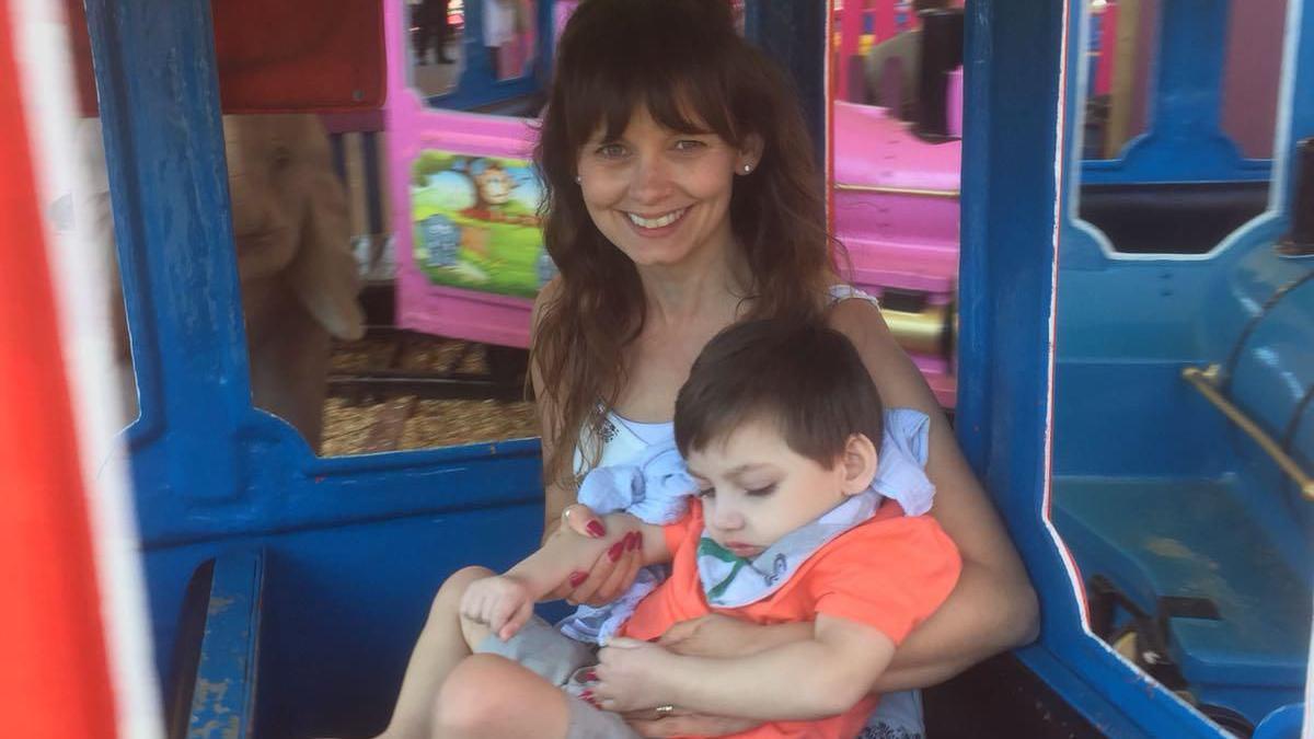 Debbie Carr holding Frankie on a train ride